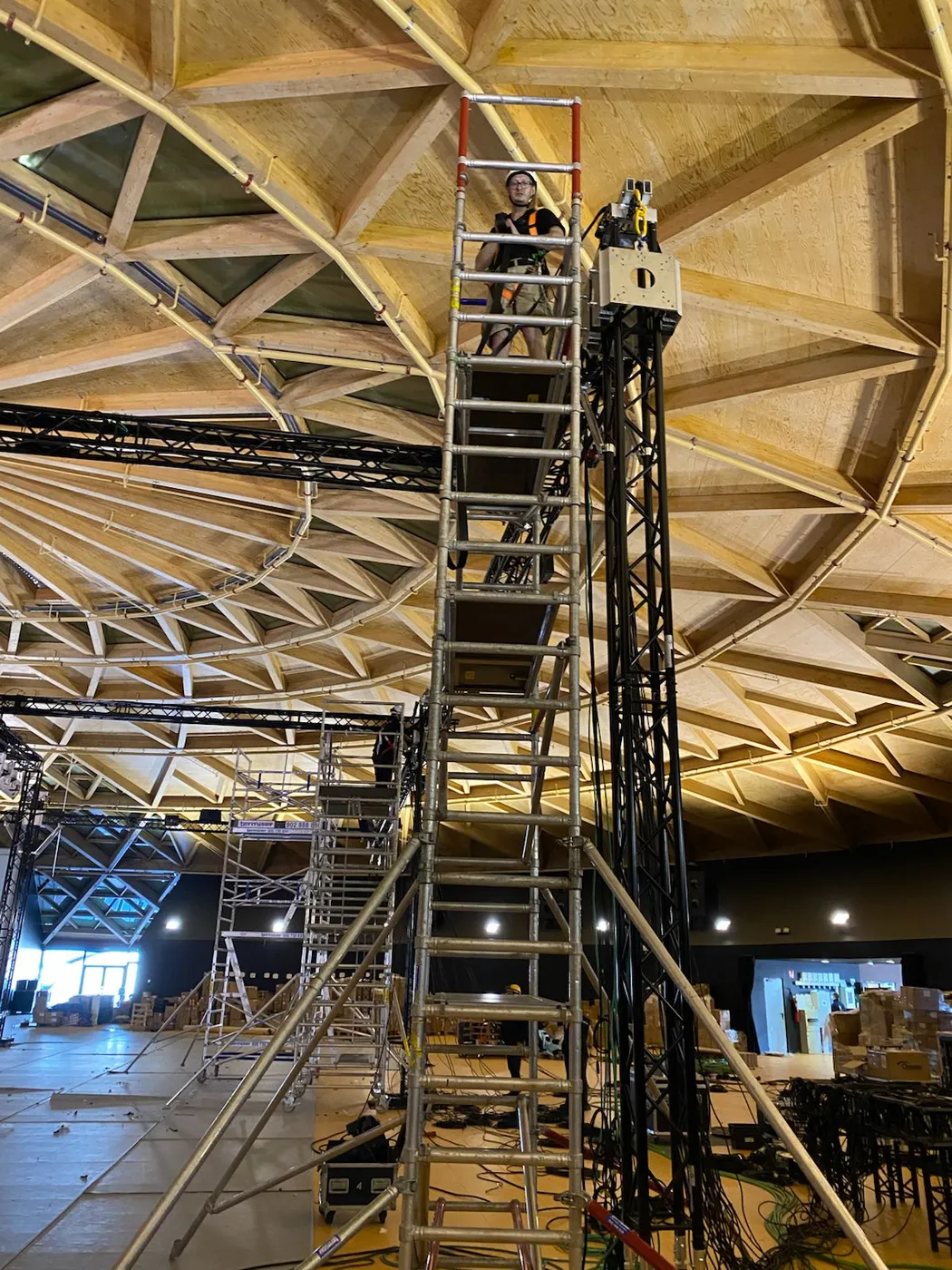 Rigging a central truss and ground-support tower under the wooden dome